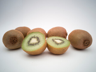 A group of kiwis on white background. Kiwi cut in half closeup.