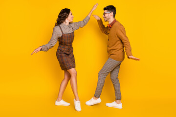 Full body profile side photo of nice happy lady and man dance good mood smile isolated on yellow color background