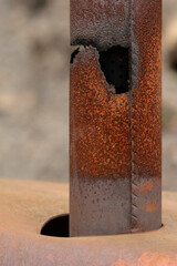 Old rusty exhaust pipe with a hole in it.