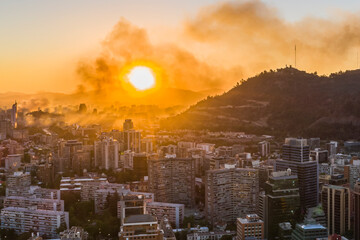 A bloody sky for a bloody city, A view of Santiago city skyline on fire during the protests that bring again chaos to the city, a huge smoke column rises from the looted commercial buildings