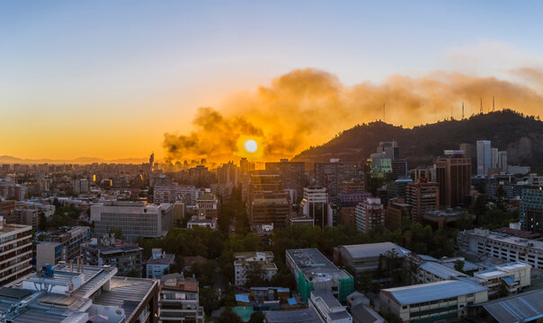 A bloody sky for a bloody city, A view of Santiago city skyline on fire during the protests that bring again chaos to the city, a huge smoke column rises from the looted commercial buildings