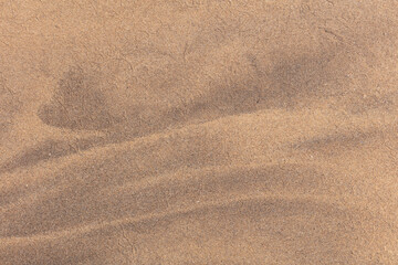Close up abstract image of golden sand at a beach with beautiful natural patterns.