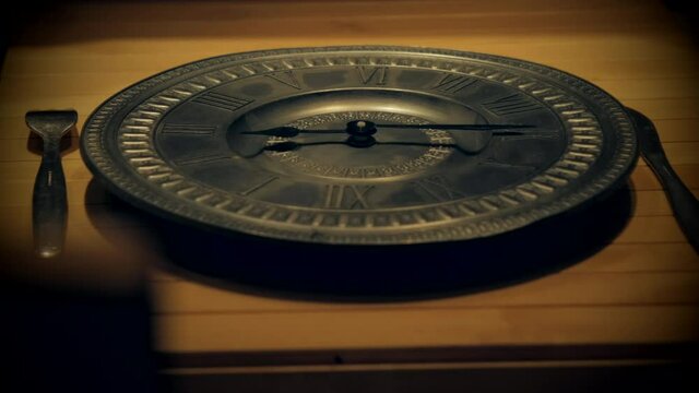 Clock hands spin rapidly on empty plate expressing concept of fasting from food