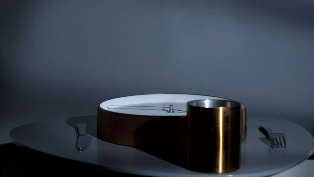 Clock on plate with hands spinning fast. Diet concept