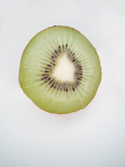 Top view on a kiwi cut in half. Half of a kiwi on white background.