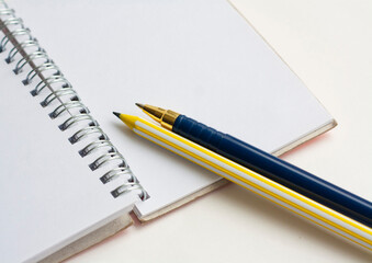 Writing and planning, notebook, yellow pencil and blue pen