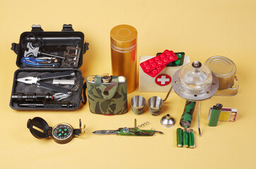 Traveler Item Set. Survival equipment in nature on a yellow background.
