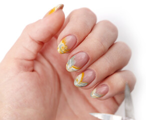 top view of hand with creative manicure and nail scissors on white background