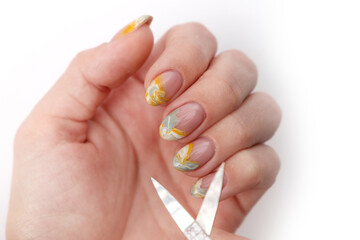 top view of hand with creative manicure and nail scissors on white background