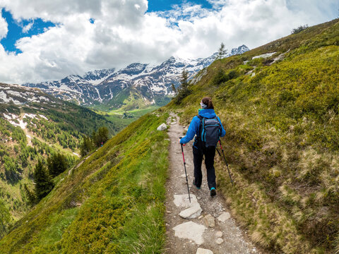 A young female hiker does trail hiking in the mountains of Gastein in Austria.
