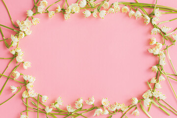 Flowers frame flat lay on pink paper. Stylish floral greeting card, space for text. Hello spring