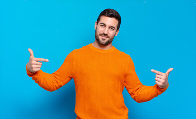 handsome adult blond man looking proud, arrogant, happy, surprised and satisfied, pointing to self,...