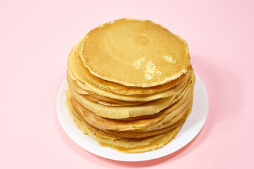 a stack of Russian pancakes on a pink background, pancakes on Shrovetide before Lent