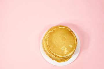 a stack of Russian pancakes on a pink background, pancakes on Shrovetide before Lent