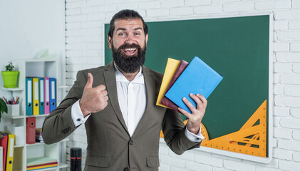 best literature. back to school. formal education. knowledge day. mature bearded teacher at lesson. brutal man work in classroom with blackboard. prepare for exam. college lecturer on lesson