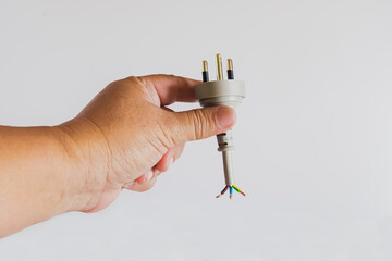 Human hand hold a damage electricity wire on white background.