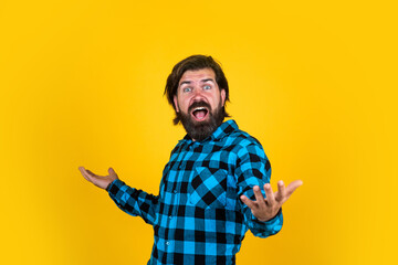 surprised brutal man in checkered shirt has long beard, surprise