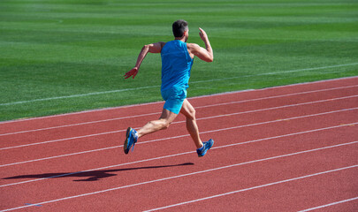 Athletic man running on sunny day, energetic