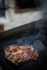 Slice of beef roasted on a barbecue grill