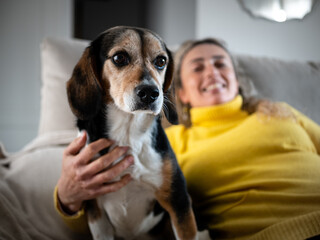 WOMAN WITH HER DOG ON THE COUCH
