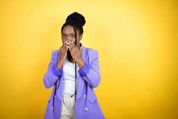 Young african american business woman shocked covering mouth with hands for mistake. secret concept.