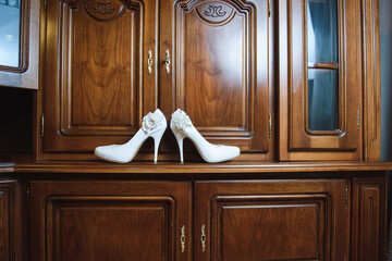 wedding shoes on wooden wardrobe