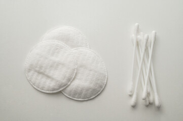 Close-up of cotton pads and cotton swabs. Top view from above. White background.