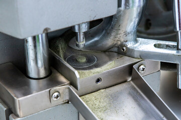 Pill made by single punch tablet machine in drugs manufacturing laboratory. 