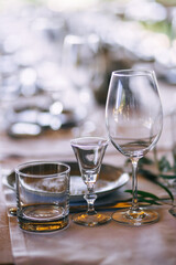 Dining table in a gourmet restaurant made of napkins and glass, tableware. Get ready to receive guests. Celebrations.