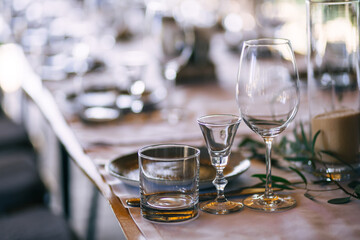 beautifully laid tables with glasses and appliances at morning in restaurant.