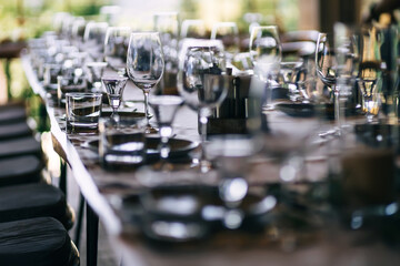 beautifully laid tables with glasses and appliances at morning i