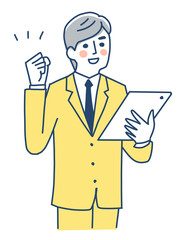 タブレット端末を持ってガッツポーズをするビジネスマン