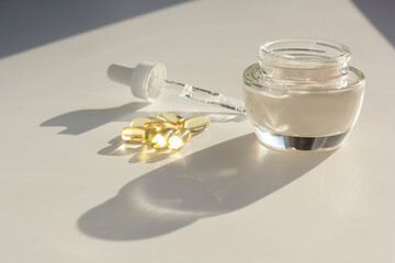 Skin care and supplements for clear and radiant skin. Closeup of beauty products and vitamin D capsules.