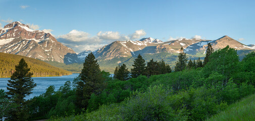 Panorama of mountains in Glacier National Park above Lower Two Medicine Lake in the morning