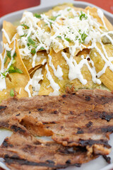 Close up of delicious breakfast of chilaquiles and coffee on a table