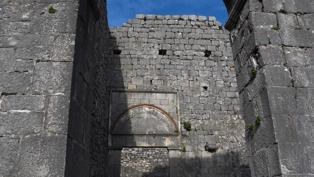 Entrance of ancient temple with arched stone walls inside castle of Rozafa