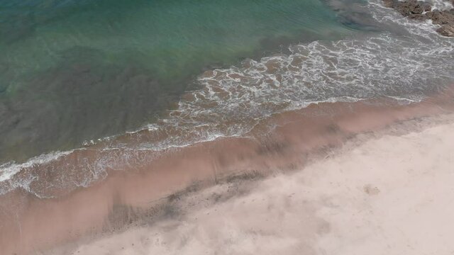 Aerial views of waves crashing at Penca beach in Guanacaste, Costa Rica