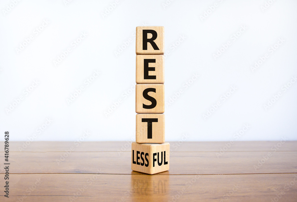 Fototapete restless or restful symbol. turned the wooden cube, changed the word 'restless' to 'restful'. beauti