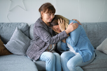 elderly mother hug crying adult daughter show support and care , supportive senior woman embrace...