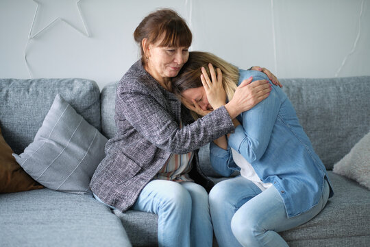 elderly mother hug crying adult daughter show support and care , supportive senior woman embrace cuddle grownup child feeling depressed, having life problems