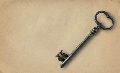 Vintage key on old paper background