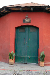 Fototapeta na wymiar wall red of clean colonial house, with wooden door green - for facade mockup