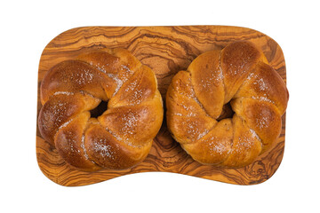 Portuguese traditional Easter cake. Folar with eggs on wooden table. Sweet bread isolated on white background
