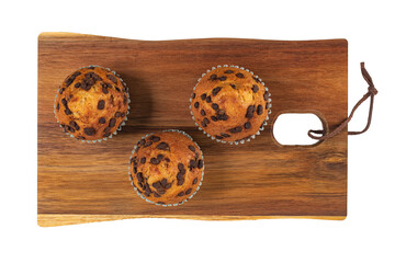 Chocolate muffins on wooden table isolated on white background