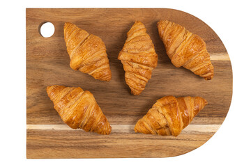 Fresh flavorous croissant on wooden table isolated on white