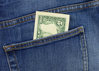 5 dollar bill in jeans pocket close-up. Pocket money concept. Cash for payment.