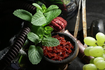 bowl with hookah tobacco. shiisha with fruits on black background.