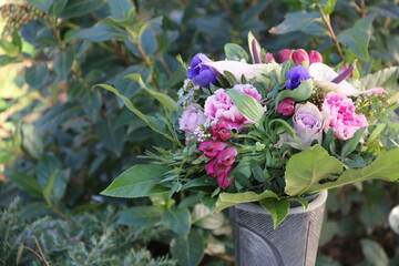 Frische Blumen im Strauss in Friedhofsvase im Frühling