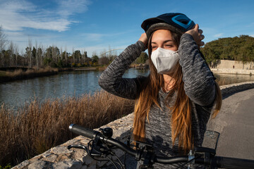 Girl for a ride with her electric bike in the park on a sunny day.