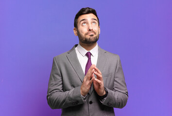 young adult handsome businessman scheming and conspiring, thinking devious tricks and cheats,...